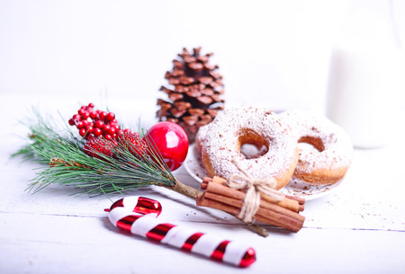 Christmas donuts on white wooden tableの写真素材