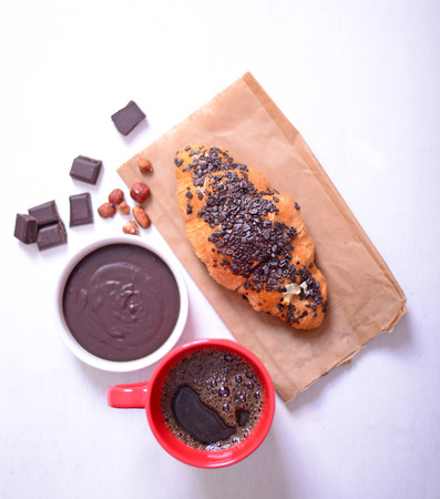 Chocolate croissant on white wooden backgroundの写真素材