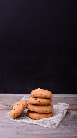 Chocolate cookies on lace napkin on black tableの写真素材