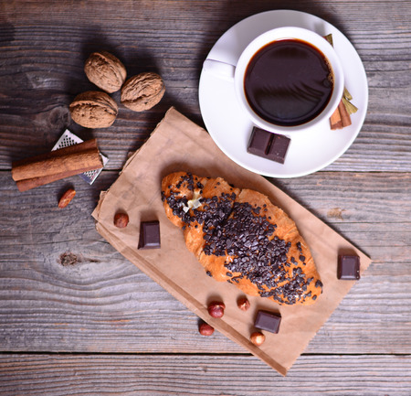 Chocolate croissant with coffee on tableの写真素材