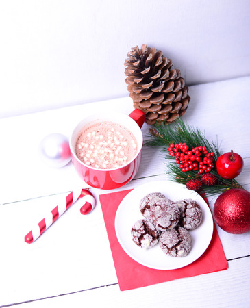 Christmas ornaments and hot chocolate with cookies on white backgroundの写真素材