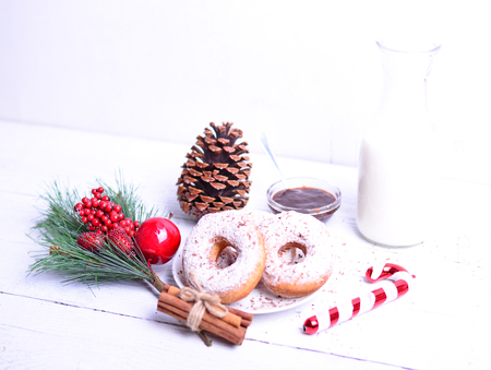 Christmas donuts on white wooden tableの写真素材