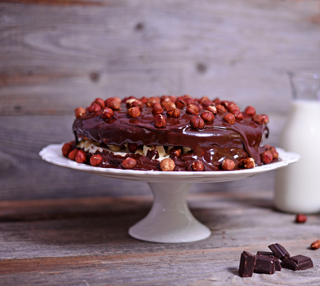 Delicious chocolate cakes with hazelnut on wooden tableの写真素材