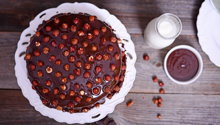 Delicious chocolate cakes with hazelnut on wooden tableの写真素材
