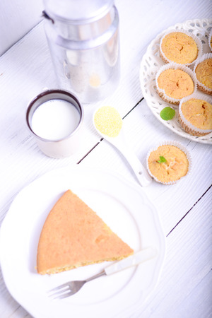 Cornbread muffins and milk on white tableの写真素材