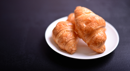 Croissants over black backgroundの写真素材