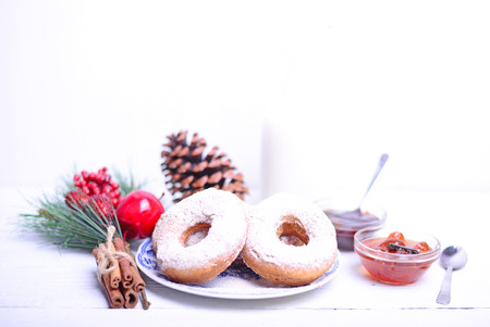 Donuts for Christmas breakfast on white wooden tableの写真素材