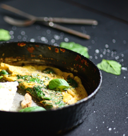 Closeup of fresh white cheese with scrambled eggs and spinachの写真素材