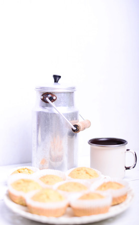 Cornbread muffins and milk on white tableの写真素材