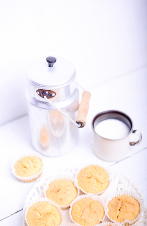 Cornbread muffins and milk on white tableの写真素材