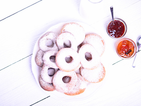 Fresh donuts on white wooden tableの写真素材