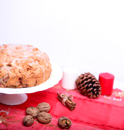 Fresh Christmas cake with apples and walnuts on tableの写真素材