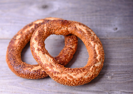 Fresh cook bagel on wooden background