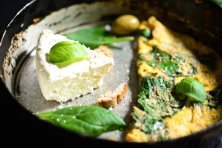 Fresh white cheese with scrambled eggs and spinach closeupの写真素材