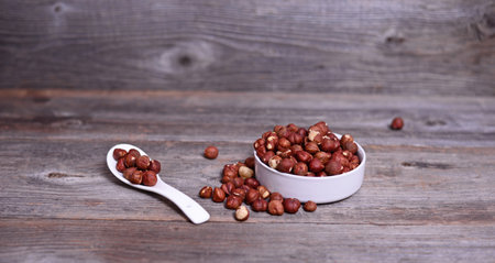 Hazelnuts on wooden tableの写真素材