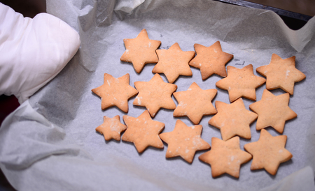 Closeup of baked christmas cookies on baking paperの写真素材