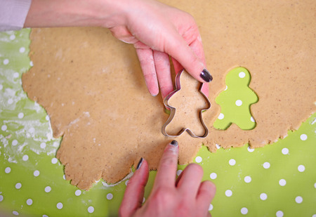 Woman hands prepare gingerbread for Christmasの写真素材