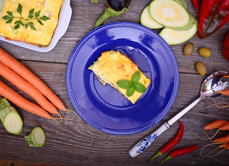 Healthy zucchini lasagna bolognese on blue plate on tableの写真素材