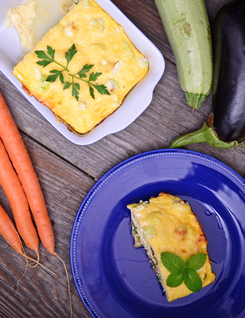 Healthy zucchini lasagna bologneseon blue plate and baking dishの写真素材