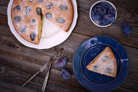 Homemade plum cake on wooden backgroundの写真素材
