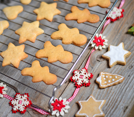Closeup of Christmas cookies on wooden table with ornamentsの写真素材