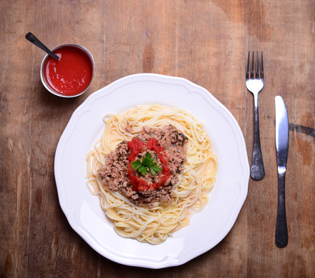 Italian spaghetti on rustic wooden tableの写真素材