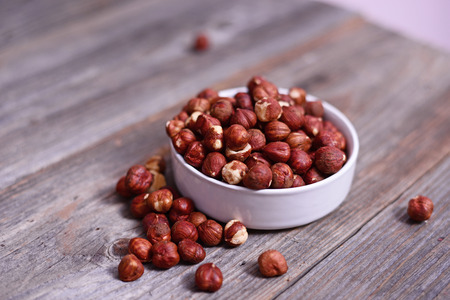 Hazelnuts on wooden tableの写真素材