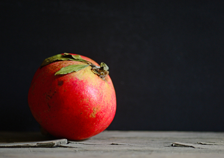 Pomegranate fruit over wooden rustic tableの写真素材