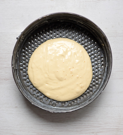 Raw dough in a round baking tinの写真素材