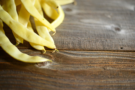 Yellow beans on old tableの写真素材