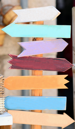Colorful blank wooden signpost with many arrowsの写真素材