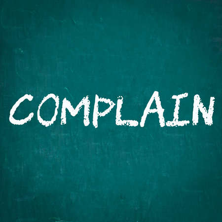 COMPLAIN written on chalkboardの写真素材