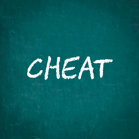 CHEAT written on chalkboardの写真素材