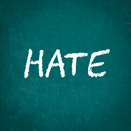 HATE written on chalkboardの写真素材
