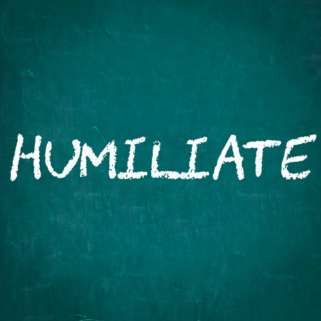 HUMILIATE written on chalkboardの写真素材
