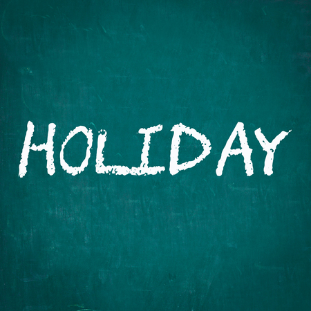 HOLIDAY written on chalkboardの写真素材