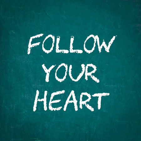 FOLLOW YOUR HEART written on chalkboardの写真素材