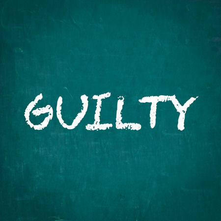 GUILTY written on chalkboardの写真素材