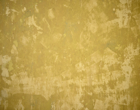 Old yellow damaged wallの写真素材