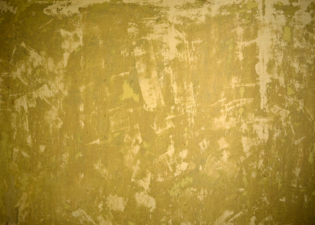 Old yellow damaged wall backgroundの写真素材