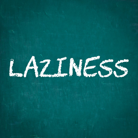 LAZINESS written on chalkboardの写真素材