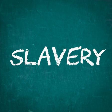 SLAVERY written on chalkboardの写真素材