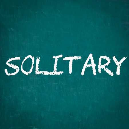SOLITARY written on chalkboardの写真素材