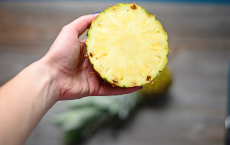 Pineapple in woman handの写真素材