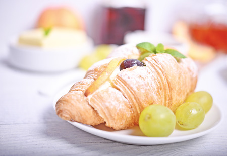 Fresh fruit croissant on white backgroundの写真素材