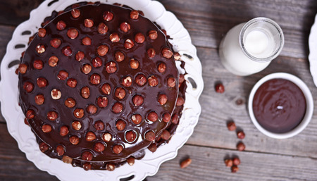 Delicious chocolate cakes with hazelnut on wooden tableの写真素材