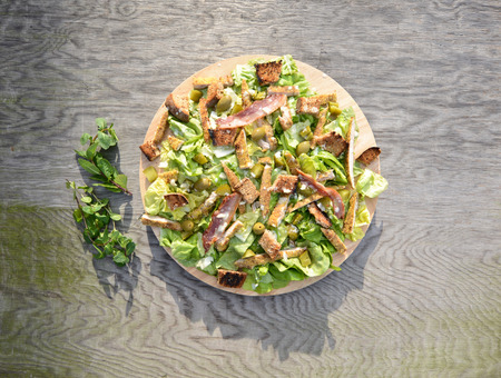 Fresh Ceaser salad on wooden tableの写真素材
