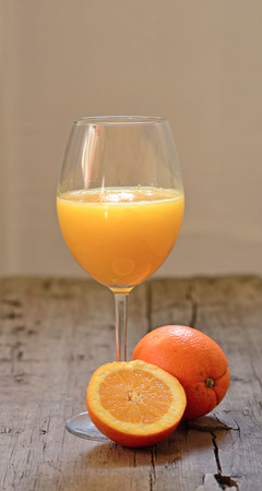 Orange juice and fresh orange on wooden backgriundの写真素材