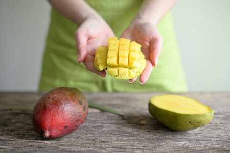 Hand Holding Fresh Mango , Cut in Square Shape Concept of Food Art, Idea of Decorated Food