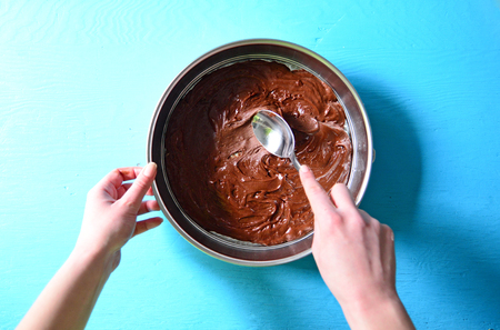 Woman hand smearing chocolate creamの写真素材